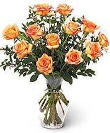 Dozen orange Roses vased and delivered 